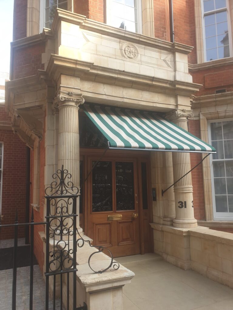 Entrance awning with green and white stripes